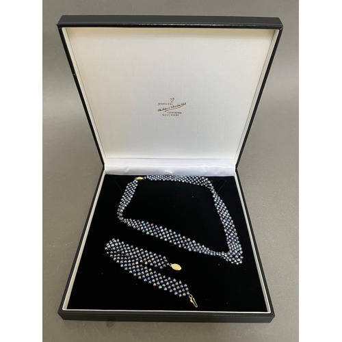 241 - A pearls necklace and a pearls bracelet both with 14k gold clasps in associated box.