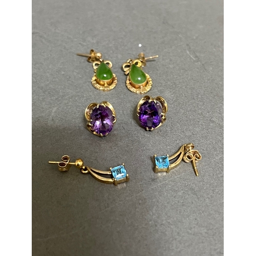 245 - Three pairs of 9ct gold earrings to include amethyst, jade and topaz.