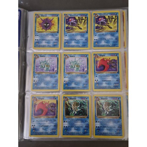 340 - A box containing two binders of vintage 1990s Pokemon cards together with a vintage Pokemon marble b... 