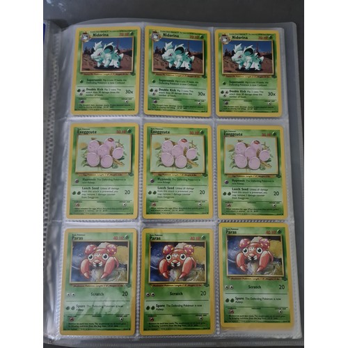 340 - A box containing two binders of vintage 1990s Pokemon cards together with a vintage Pokemon marble b... 