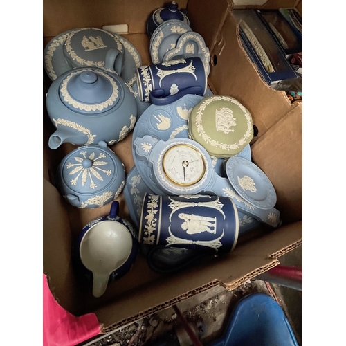 656 - A box of mostly blue and white Wedgewood jasperware including teapot, barometer, jugs, lidded dishes... 