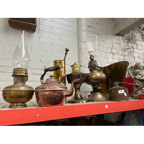 122 - Quantity of copper and brass items including lamps, coal bucket, kettle and watering can.