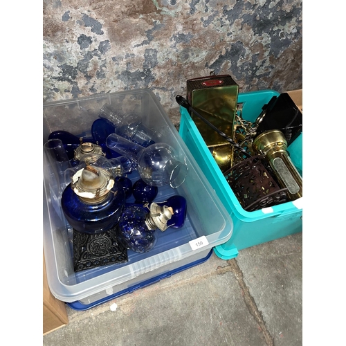 150 - A collection of old parafin lamps to include blue cobalt, etc and a box of metalware, mainly brass.