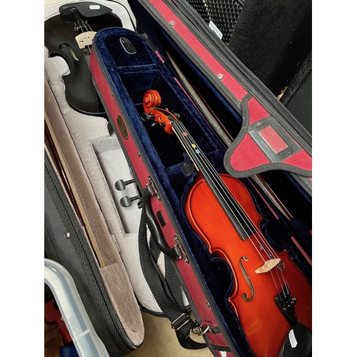 78 - Two student violins, one black, one Stentor Student II half size, both in cases with bows together w... 