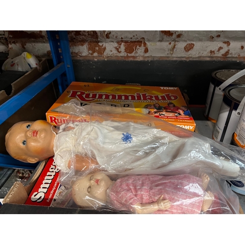 234 - A box containing various board games and a vintage doll.