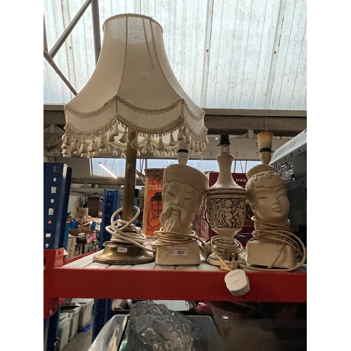 302 - A brass column table lamp and 3 eastern design pottery lamps