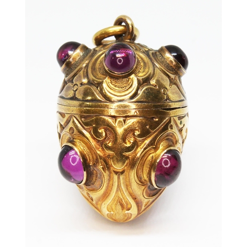 1 - A gilt metal vinaigrette, circa 1900, egg form and engraved, set with eight rhodolite garnet cabocho... 