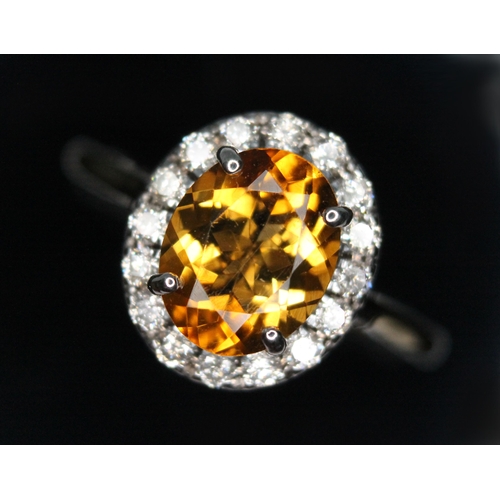 17 - A diamond and citrine cluster ring, the oval cluster measuring approx. 13.60mm x 12.10mm, hallmarked... 