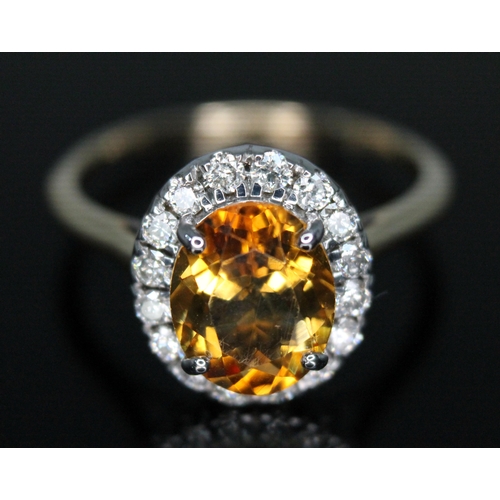 17 - A diamond and citrine cluster ring, the oval cluster measuring approx. 13.60mm x 12.10mm, hallmarked... 