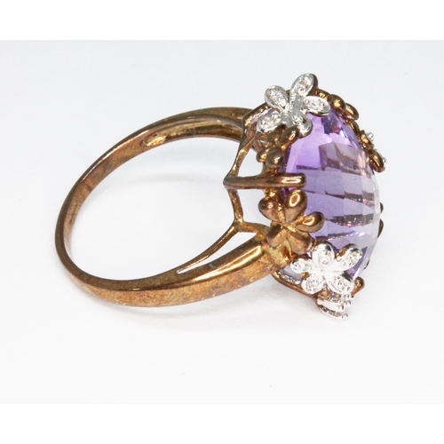 113 - A 9ct gold ring featuring a rectangular rose cut amethyst, floral setting set with diamonds, hallmar... 