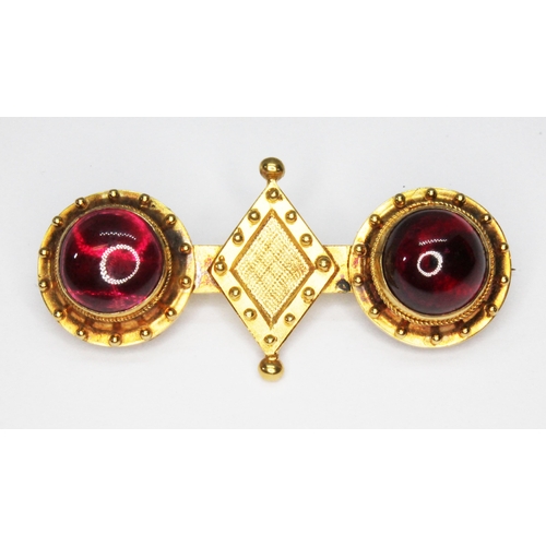 79 - A Victorian yellow metal and rhodolite garnet cabochon brooch, unmarked, length 46mm, gross wt. 7.6g... 