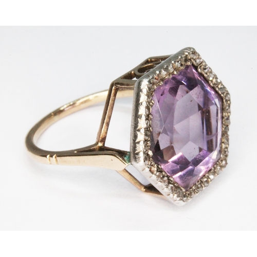 234 - An early 20th century amethyst and diamond cluster ring, the central hexagonal cut stone measuring a... 