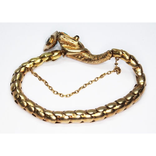 244 - A Victorian serpent bracelet, the head embellished with turquoise cabochons and garnet set eyes, the... 