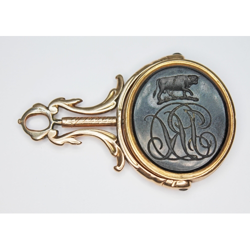 248 - A 19th century swivel fob, black stone intaglio carving depicting an armorial crest to one side and ... 