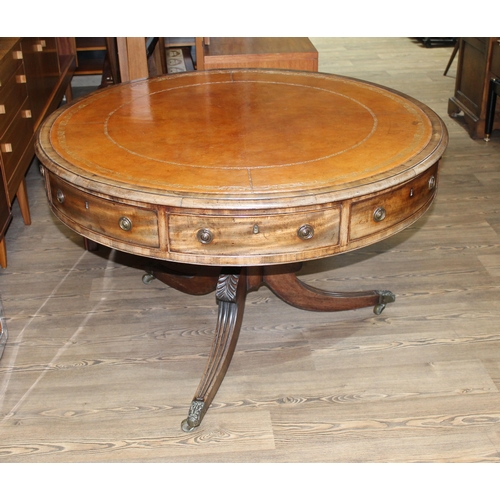 299 - A Regency mahogany drum table, revolving tooled leather top, four drawers, three dummy drawers and o... 