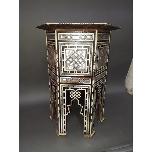 301 - A Moorish bone and mother of pearl inlaid occasional table, height 78cm.