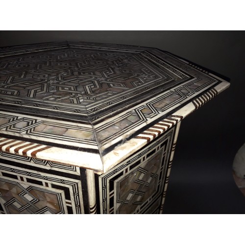 301 - A Moorish bone and mother of pearl inlaid occasional table, height 78cm.