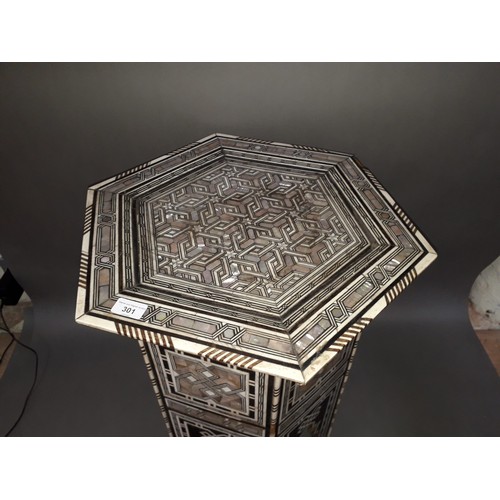 301 - A Moorish bone and mother of pearl inlaid occasional table, height 78cm.