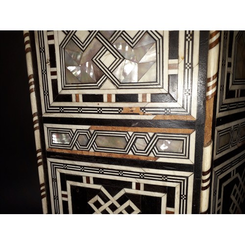 301 - A Moorish bone and mother of pearl inlaid occasional table, height 78cm.