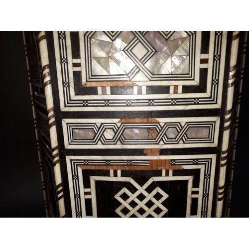 301 - A Moorish bone and mother of pearl inlaid occasional table, height 78cm.