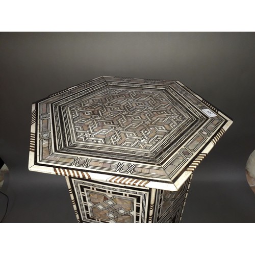 301 - A Moorish bone and mother of pearl inlaid occasional table, height 78cm.