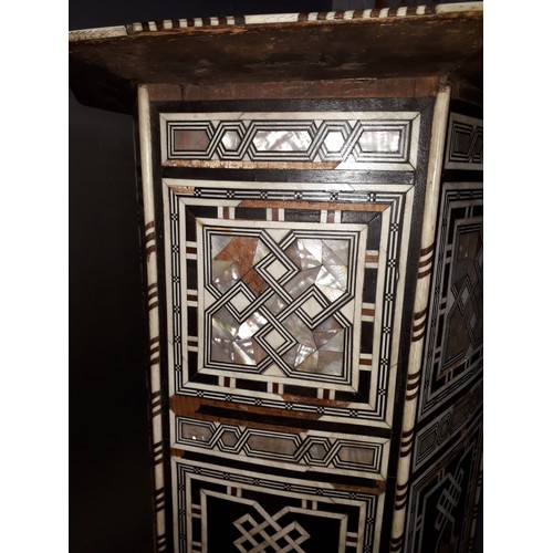 301 - A Moorish bone and mother of pearl inlaid occasional table, height 78cm.