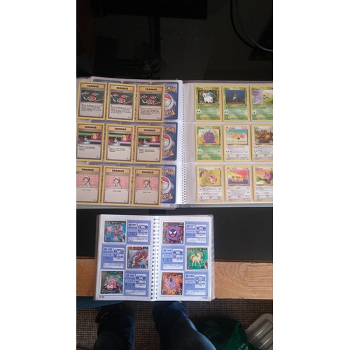 162 - A box containing two binders of vintage 1990s Pokemon cards together with a perfect album 3 sticker ... 