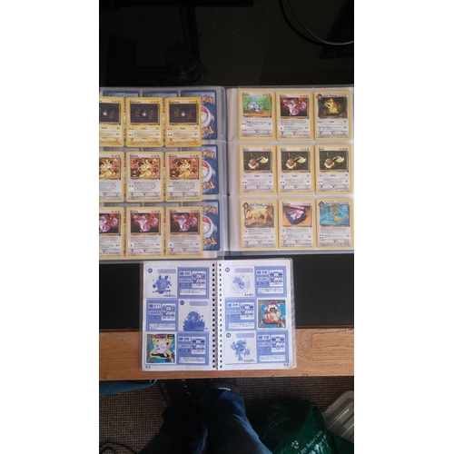 162 - A box containing two binders of vintage 1990s Pokemon cards together with a perfect album 3 sticker ... 