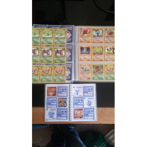 162 - A box containing two binders of vintage 1990s Pokemon cards together with a perfect album 3 sticker ... 