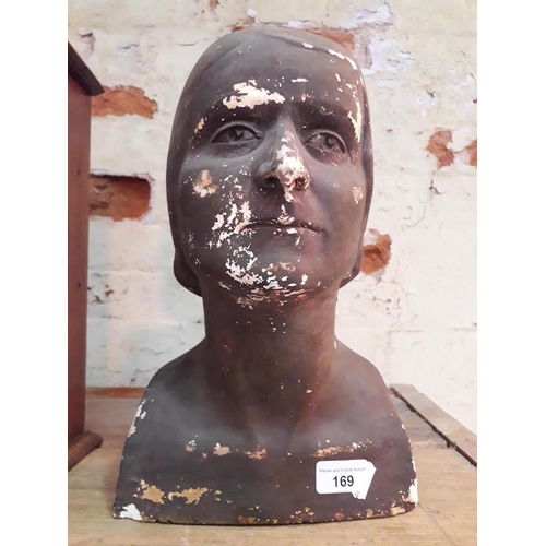 169 - A plaster death mask, depicting a female bust, indistinctly signed 