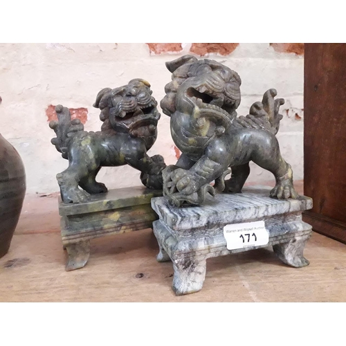 171 - A pair of carved stone dogs of fo.