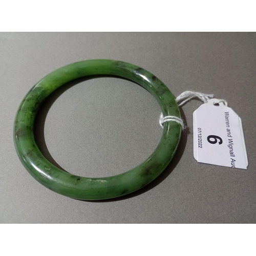 6 - A nephrite jade bangle, diameter 7cm, wt. 33.9g.