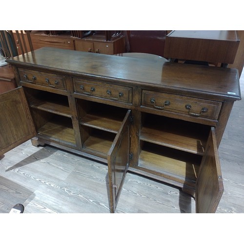 303 - A reproduction aged oak sideboard, length 169cm, depth 46cm & height 89cm.