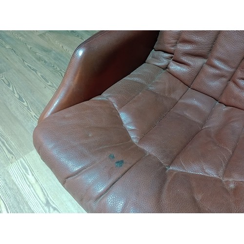 318 - A pair of Norwegian Ring Mekanikk tan leather lounge swivel chairs, previously the property of Jack ... 