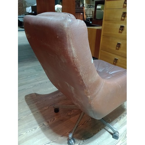 318 - A pair of Norwegian Ring Mekanikk tan leather lounge swivel chairs, previously the property of Jack ... 