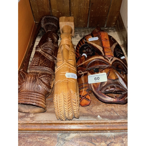 60 - Two African carved wood masks and two other African carved wood ornaments.