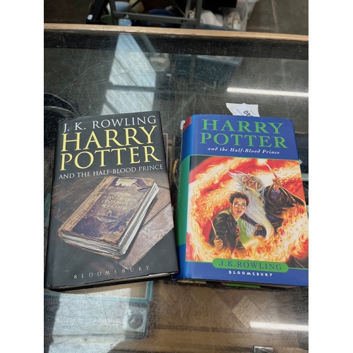 Two first editions Harry Potter books with spelling errors on page 99 ...