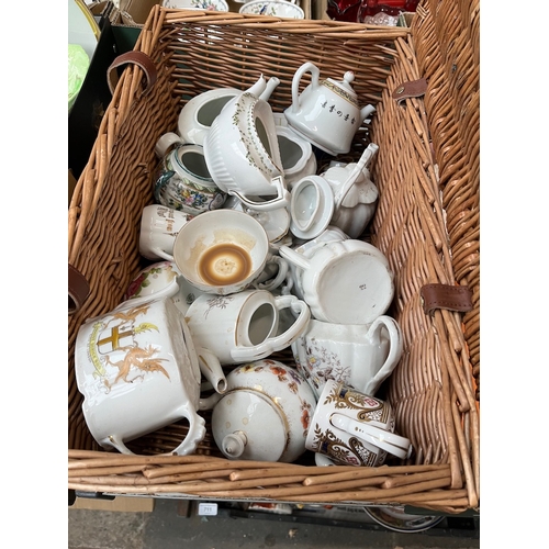 702 - A wicker hamper (F&M) containing mainly small teapots etc including Spode