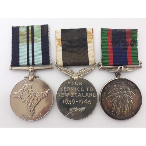 91 - A group of three unnamed medals comprising a Canadian Volunteer Service Medal 1939-45, New Zealand W... 