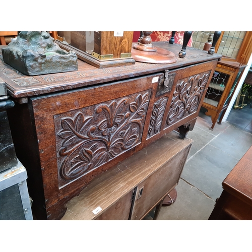 942 - An 18th century carved oak coffer.