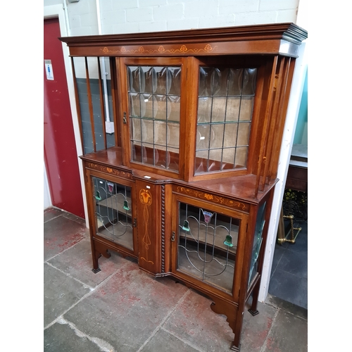 946 - An Arts & Crafts inlaid mahogany and leaded glass display cabinet.