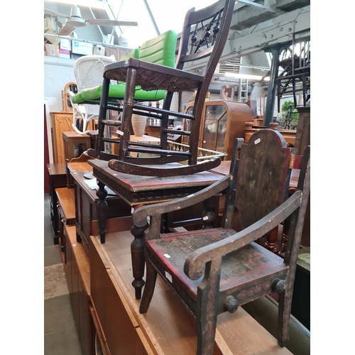 954 - A folk art painted child's table and chair together with a rush seated child's rocking chair.