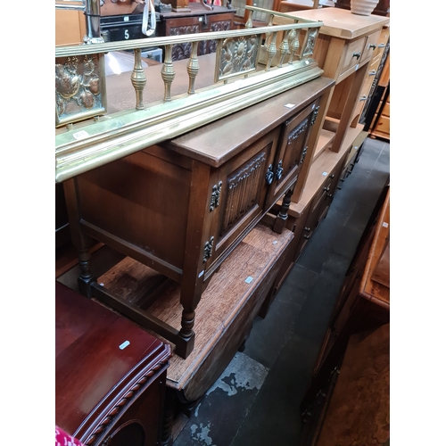 960 - A brass fender, an Old Charm oak side cabinet and an oak drop leaf table with twist legs.