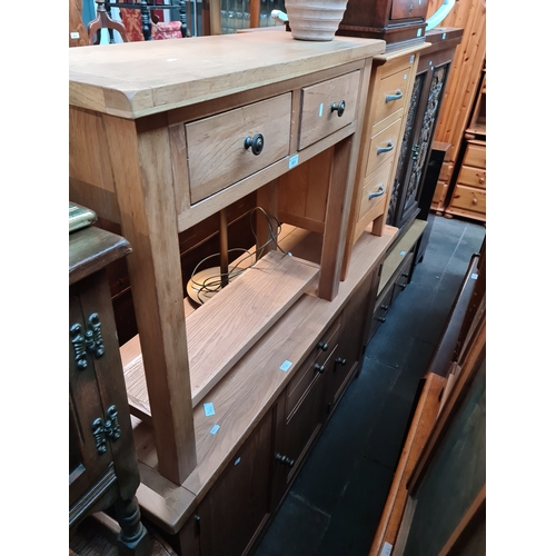 961 - A modern light oak sideboard and matching TV stand together with a modern light oak two drawer side ... 