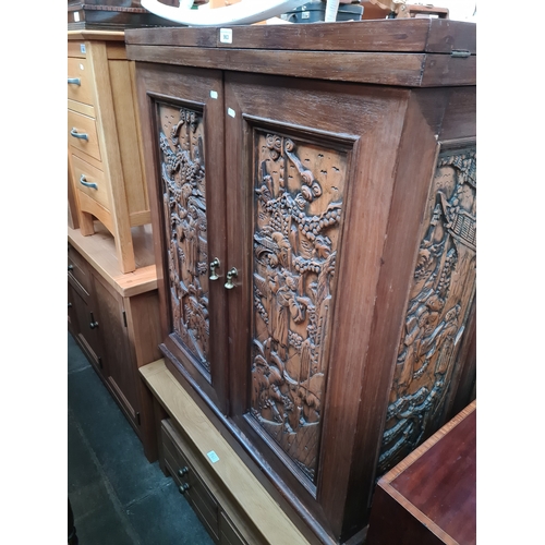 963 - A Chinese carved wood fold out cocktail cabinet/ bar.