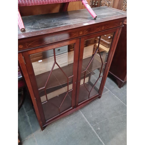 964 - A glazed inlaid mahogany display cabinet.