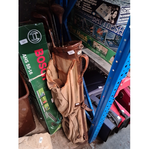 322 - Two vintage golf bags and clubs.