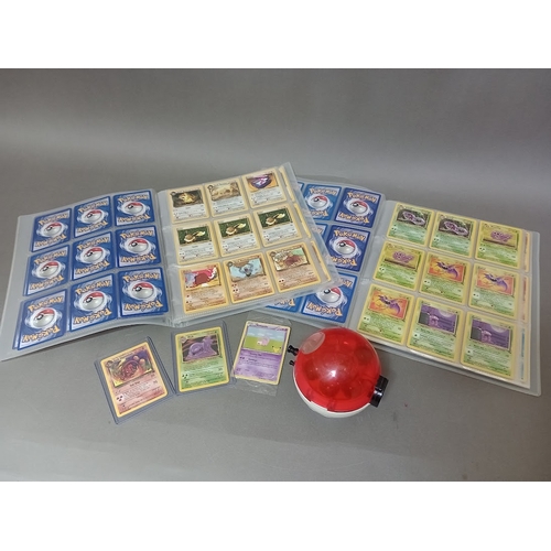 115 - A box containing two binders of vintage 1990s Pokemon cards together with a vintage Pokemon marble b... 