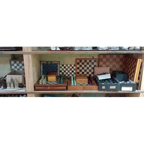 127 - Seven chess sets, various materials and shapes together with boards, wooden boxes, etc.