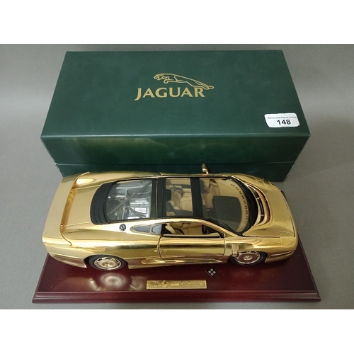 148 - Model of Jaguar XJ220 22ct gold plated car, boxed with certificate, made by GWILO Limited Edition.